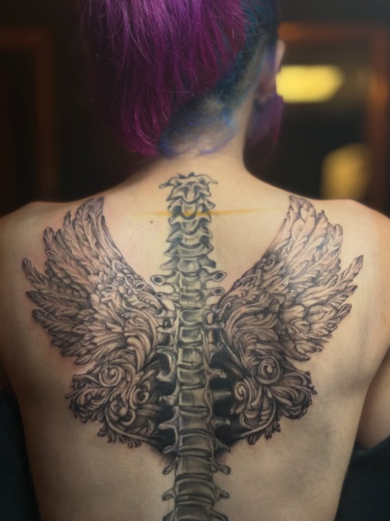 tainted flesh spine wing back tattoo placement.jpg 768x1024